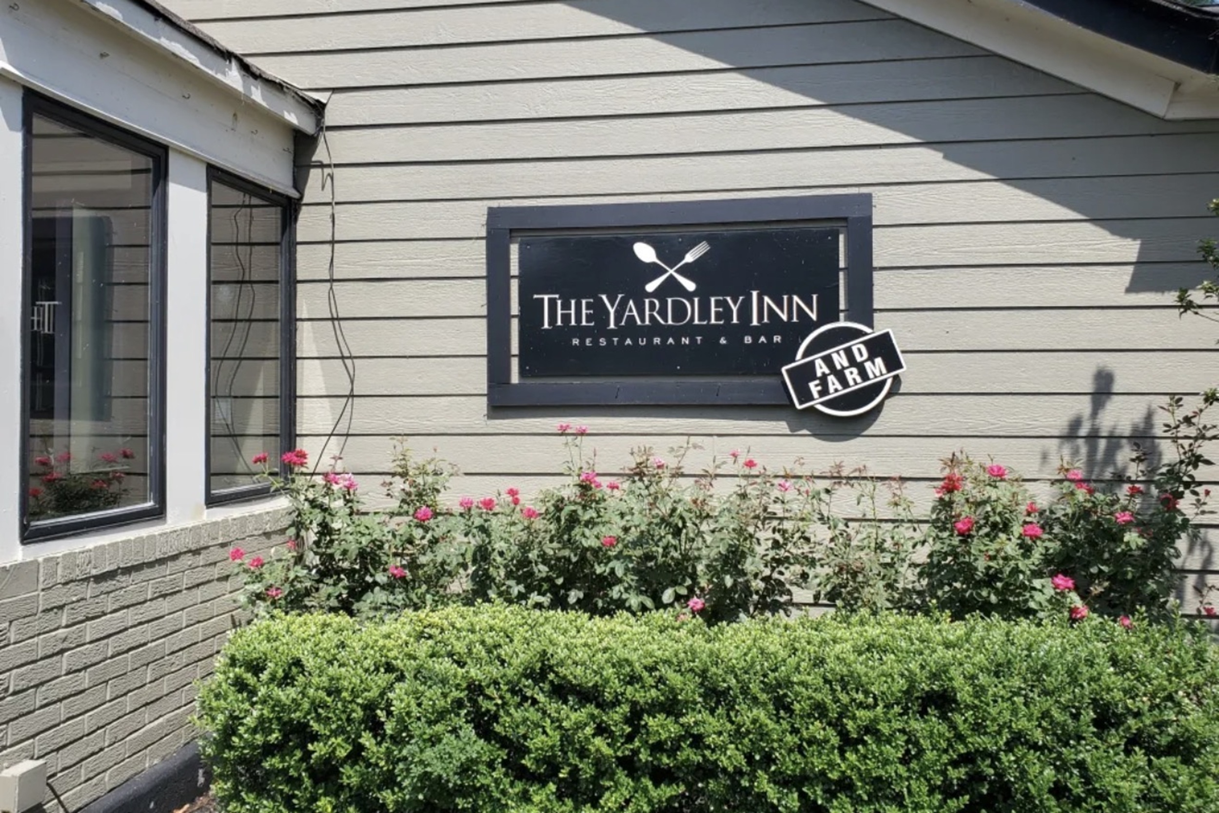 The Yardley Inn Restaurant & Bar And Farm badge nearby, pink roses in front.